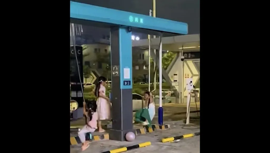 Children swing from BYD megawatt charger cable in Nanning